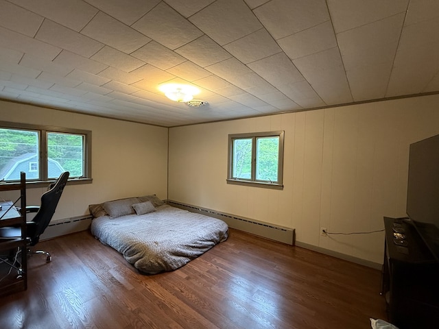 213 2nd St, Harrison Valley, PA 16927 - bedroom with multiple windows, a baseboard radiator, and wood finished floors
