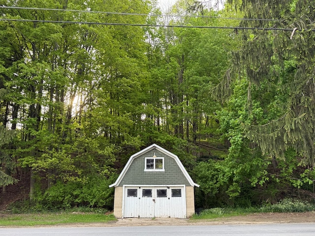 213 2nd St, Harrison Valley, PA 16927 - garage featuring a view of trees and a garage