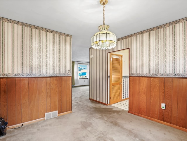113 Hemlock Rd, Sayre, PA 18840 - unfurnished dining area featuring a chandelier, a wainscoted wall, wallpapered walls, carpet floors, and wood walls