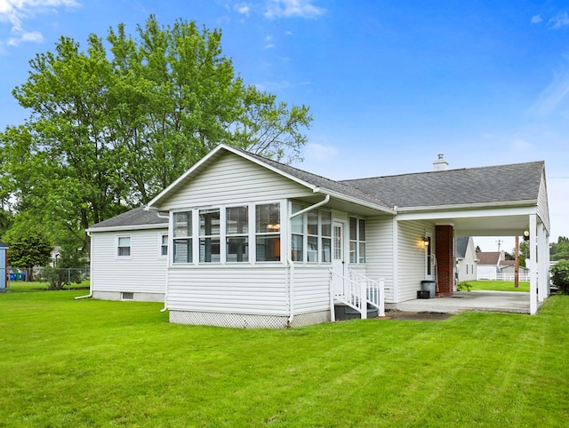 113 Hemlock Rd, Sayre, PA 18840 - back of house featuring a lawn, roof with shingles, a chimney, entry steps, and a sunroom