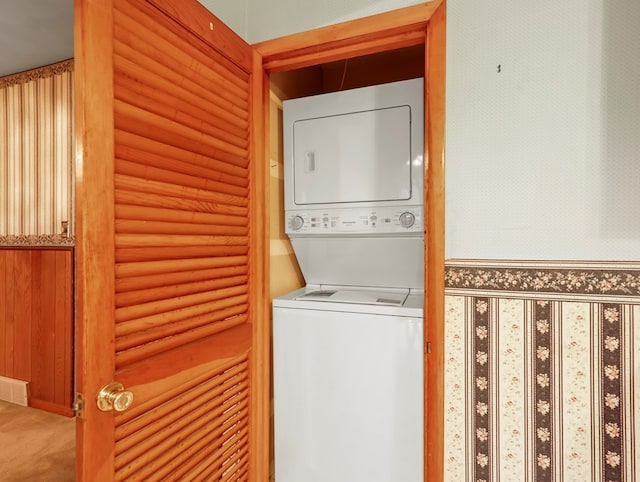 113 Hemlock Rd, Sayre, PA 18840 - laundry room with estacked washer and dryer, log walls, and carpet flooring
