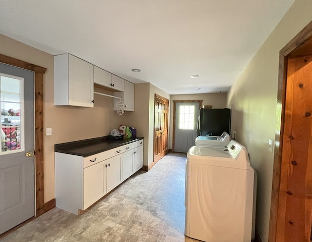 kitchen featuring white cabinets, independent washer and dryer, and fridge