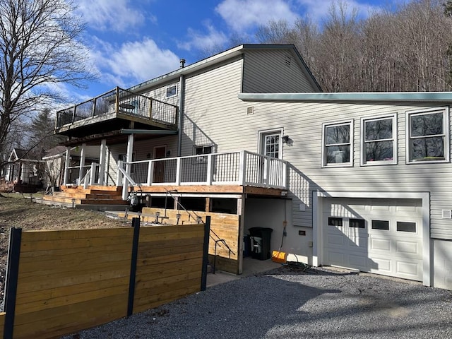 rear view of property featuring a garage