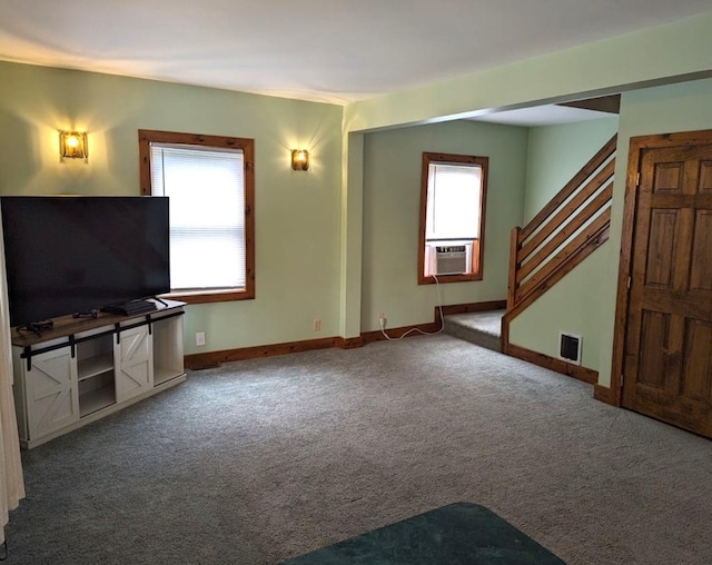 unfurnished living room with cooling unit, carpet, and a healthy amount of sunlight