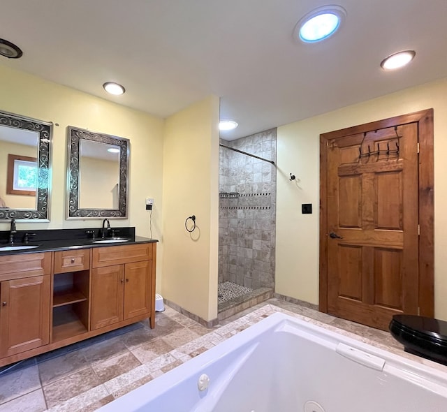 bathroom featuring vanity and independent shower and bath