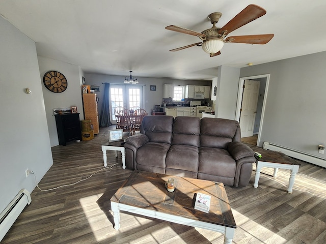 living room with ceiling fan with notable chandelier, a baseboard radiator, and wood finished floors