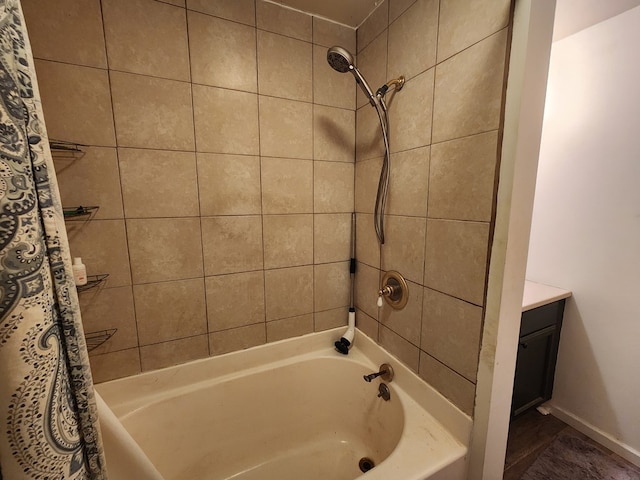 full bathroom featuring shower / tub combo, baseboards, and vanity