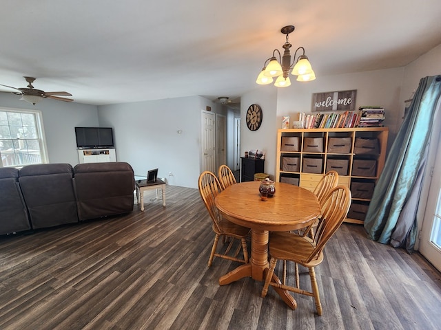 dining space featuring dark wood finished floors and ceiling fan with notable chandelier