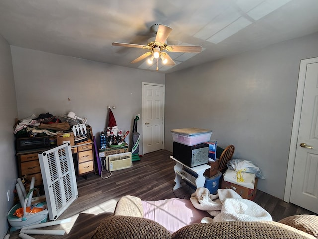 bedroom with a ceiling fan and dark wood-type flooring