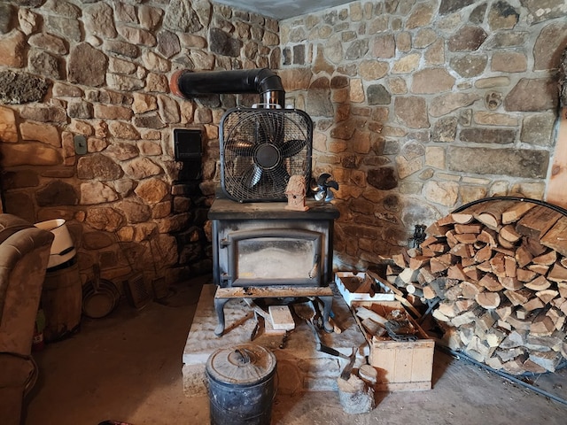 details featuring a wood stove and concrete floors