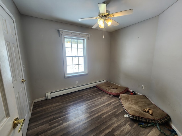 interior space featuring a baseboard radiator, baseboards, ceiling fan, and dark wood-type flooring