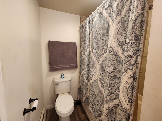 bathroom featuring toilet, baseboards, baseboard heating, and wood finished floors