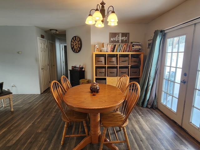 dining room with dark wood-style floors, a chandelier, and french doors