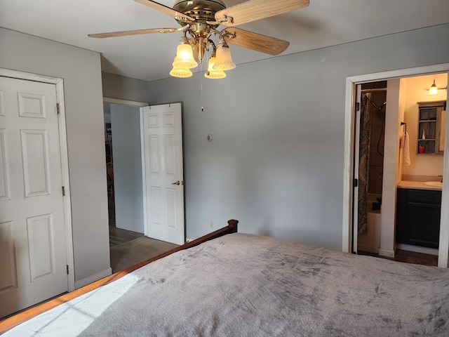 unfurnished bedroom featuring ceiling fan, ensuite bath, and dark wood-style floors