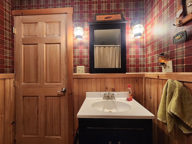 bathroom with vanity and wallpapered walls