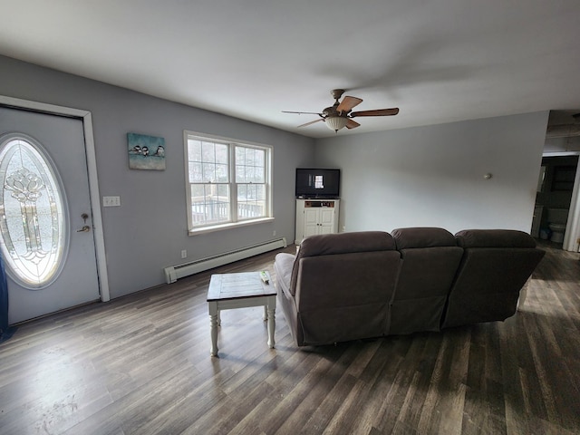 living room with ceiling fan, a baseboard radiator, and dark wood finished floors