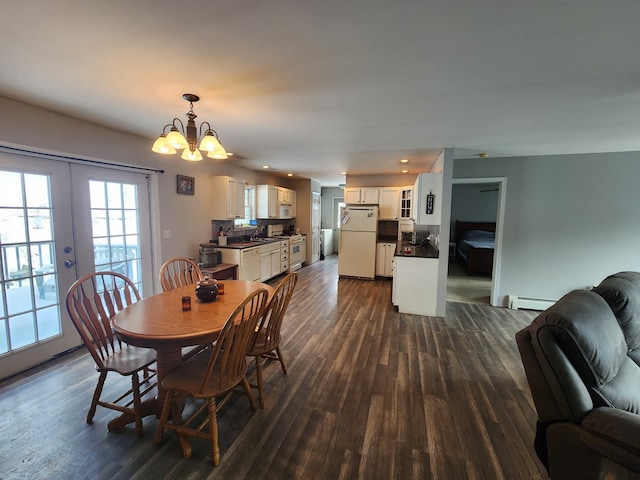 dining area featuring dark wood-type flooring, recessed lighting, french doors, and baseboard heating