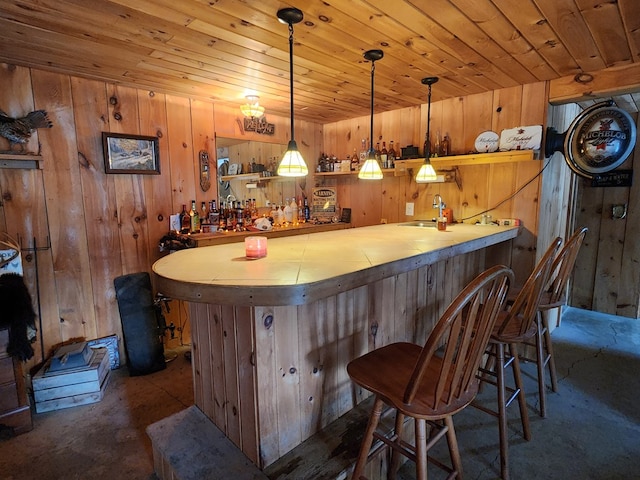 bar with hanging light fixtures, a dry bar, a sink, and wood ceiling