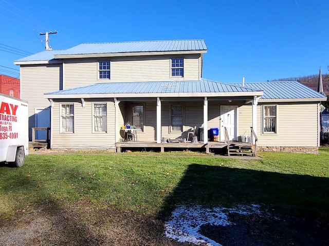 back of house with a porch and a yard