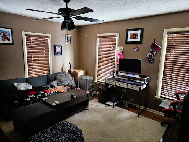 bedroom with ceiling fan, baseboards, and a textured ceiling