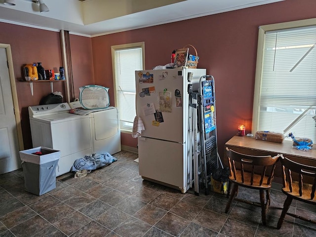 washroom featuring laundry area, ornamental molding, stone finish floor, and washer and dryer