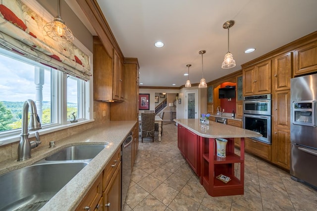 kitchen featuring sink, crown molding, a kitchen island, pendant lighting, and stainless steel appliances