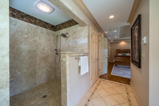 bathroom with tile patterned flooring and a tile shower