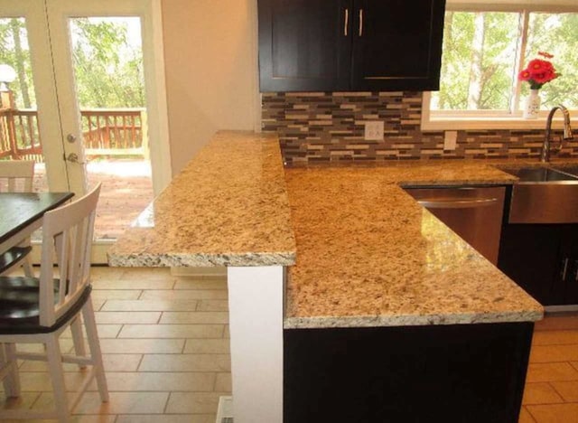 408 W Honeoye St, Shinglehouse, PA 16748 - kitchen featuring tasteful backsplash, healthy amount of natural light, and light stone counters