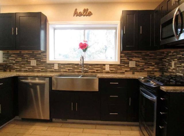 408 W Honeoye St, Shinglehouse, PA 16748 - kitchen with stainless steel appliances, decorative backsplash, light stone counters, and dark cabinetry