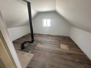 additional living space featuring lofted ceiling and dark wood-type flooring