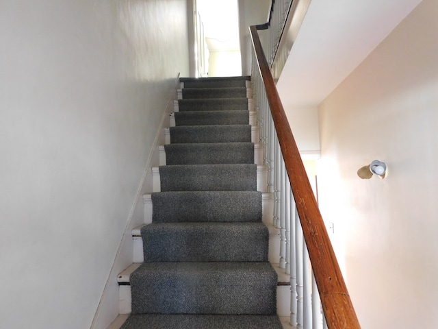 stairway featuring baseboards