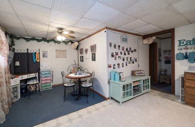 dining room featuring a paneled ceiling, carpet floors, and ceiling fan