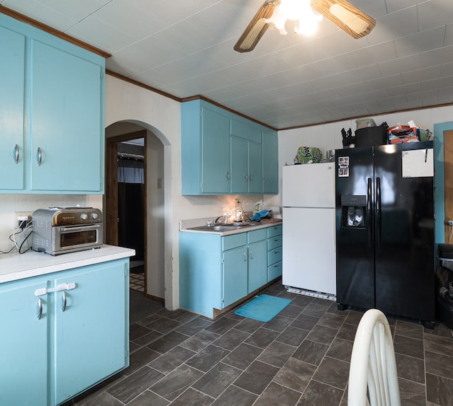 kitchen featuring ornamental molding, black fridge with ice dispenser, blue cabinets, ceiling fan, and white fridge