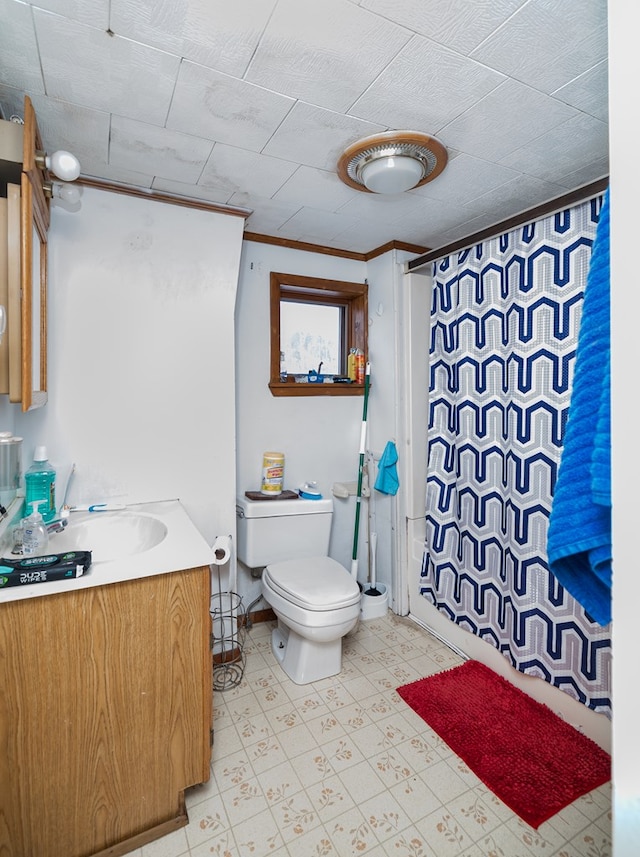 bathroom featuring vanity, toilet, and crown molding