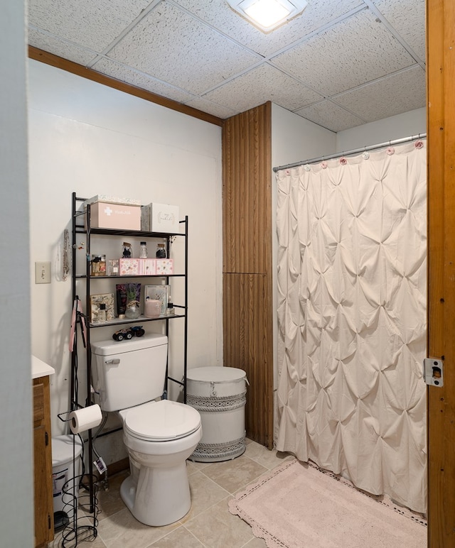 bathroom featuring tile patterned flooring, toilet, a paneled ceiling, vanity, and a shower with shower curtain