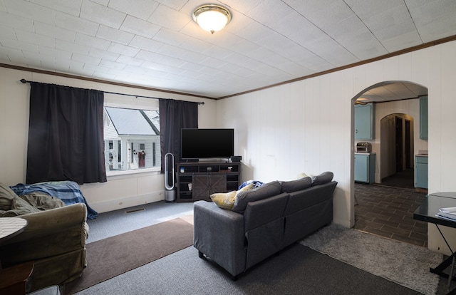 carpeted living room with crown molding