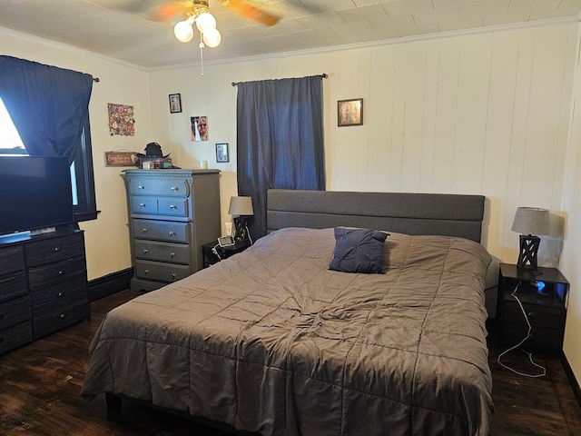 bedroom featuring crown molding, wood finished floors, baseboards, and ceiling fan