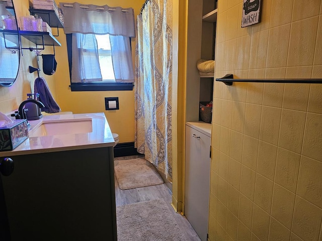 full bath with vanity, a shower with curtain, and wood finished floors