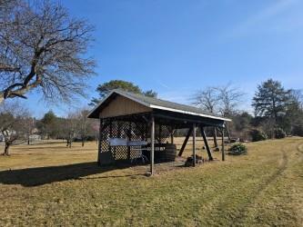 view of community featuring a yard and an outbuilding