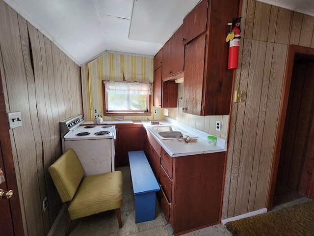 kitchen featuring range with electric cooktop, wooden walls, lofted ceiling, and sink