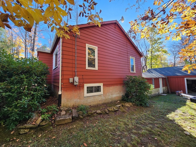 view of property exterior featuring a lawn