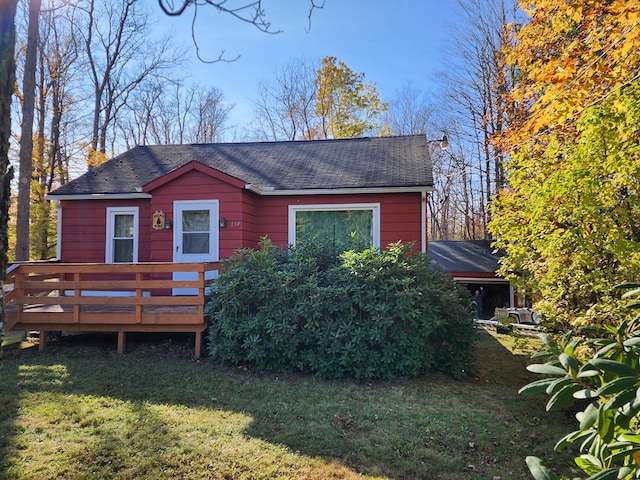 view of front facade featuring a front lawn and a deck