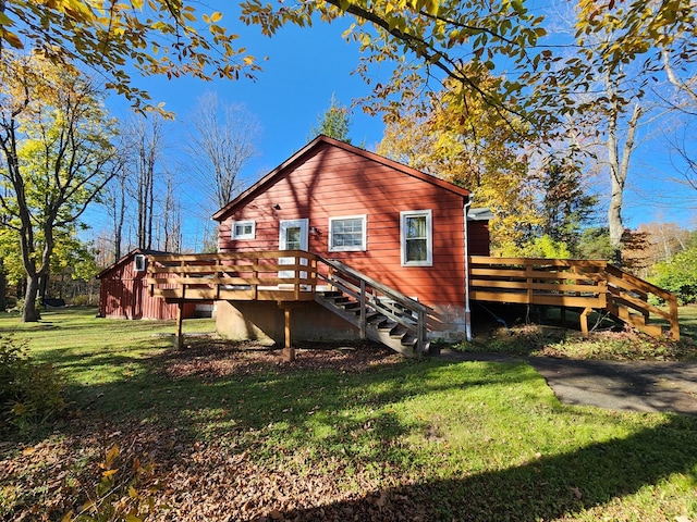 back of house with a lawn and a deck