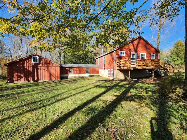 view of yard featuring an outbuilding and a wooden deck