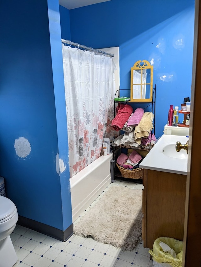 full bathroom with vanity, shower / bath combination with curtain, and toilet