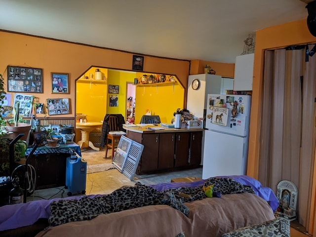 kitchen with dark brown cabinets and white refrigerator