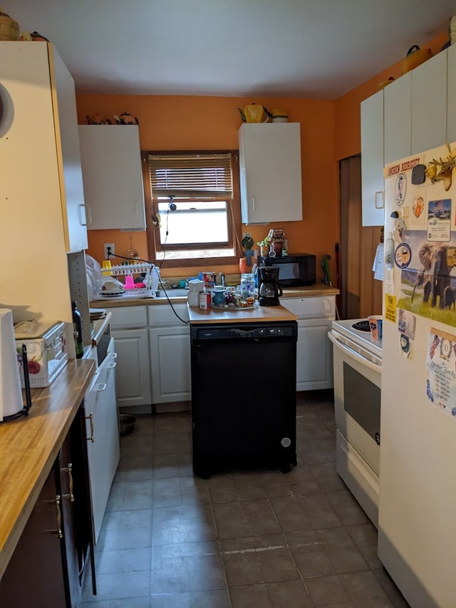 kitchen featuring black appliances, white cabinetry, and sink