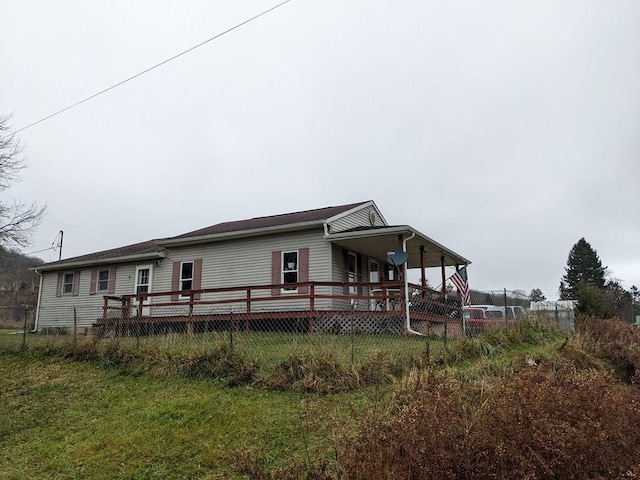 back of property with a wooden deck