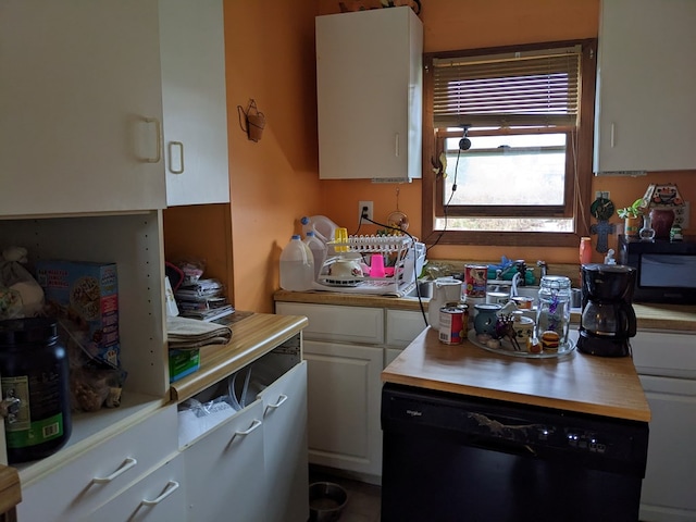 kitchen featuring dishwasher and white cabinetry