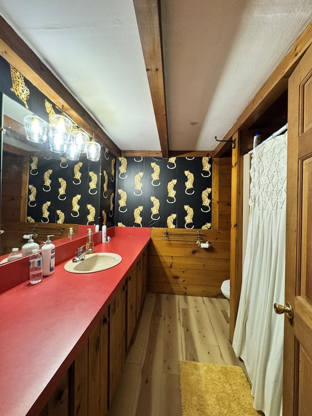971 Indian Creek Rd, Eldred, PA 16731 - bathroom featuring hardwood / wood-style flooring, vanity, wallpapered walls, and beam ceiling